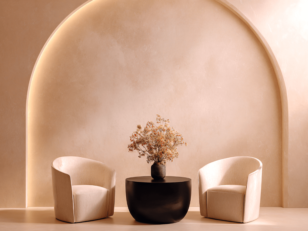 Calm, light-filled interior with two chairs and a table, symbolising a safe and supportive space for listening and one-to-one well-being guidance.